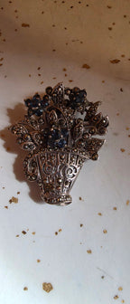 Sterling flower basket brooch (some stones missing)