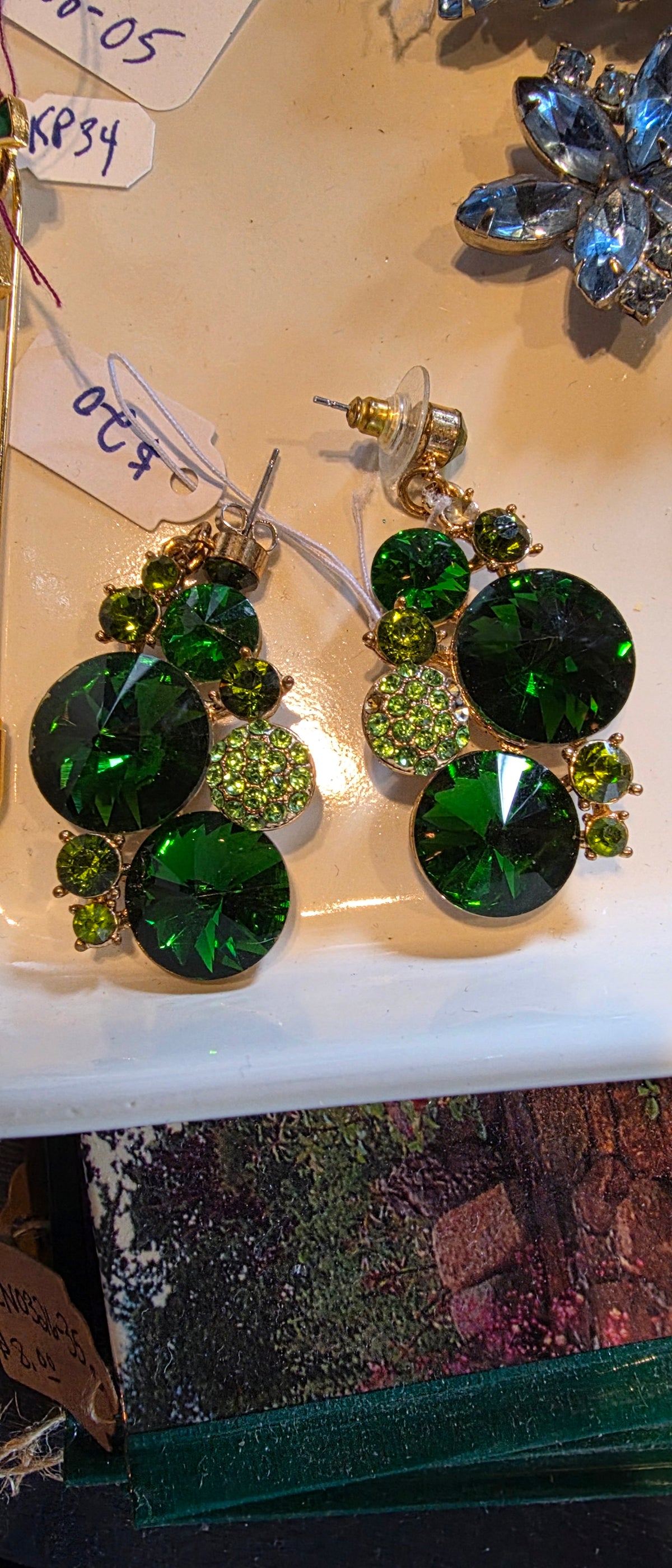Emerald green earrings (missing 1 stone)