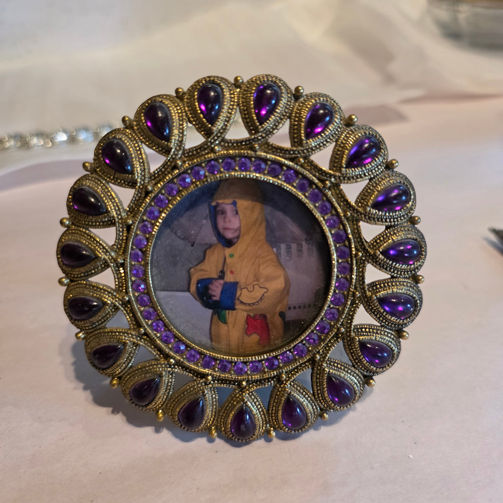 Round gold tone w purple stones picture frame
