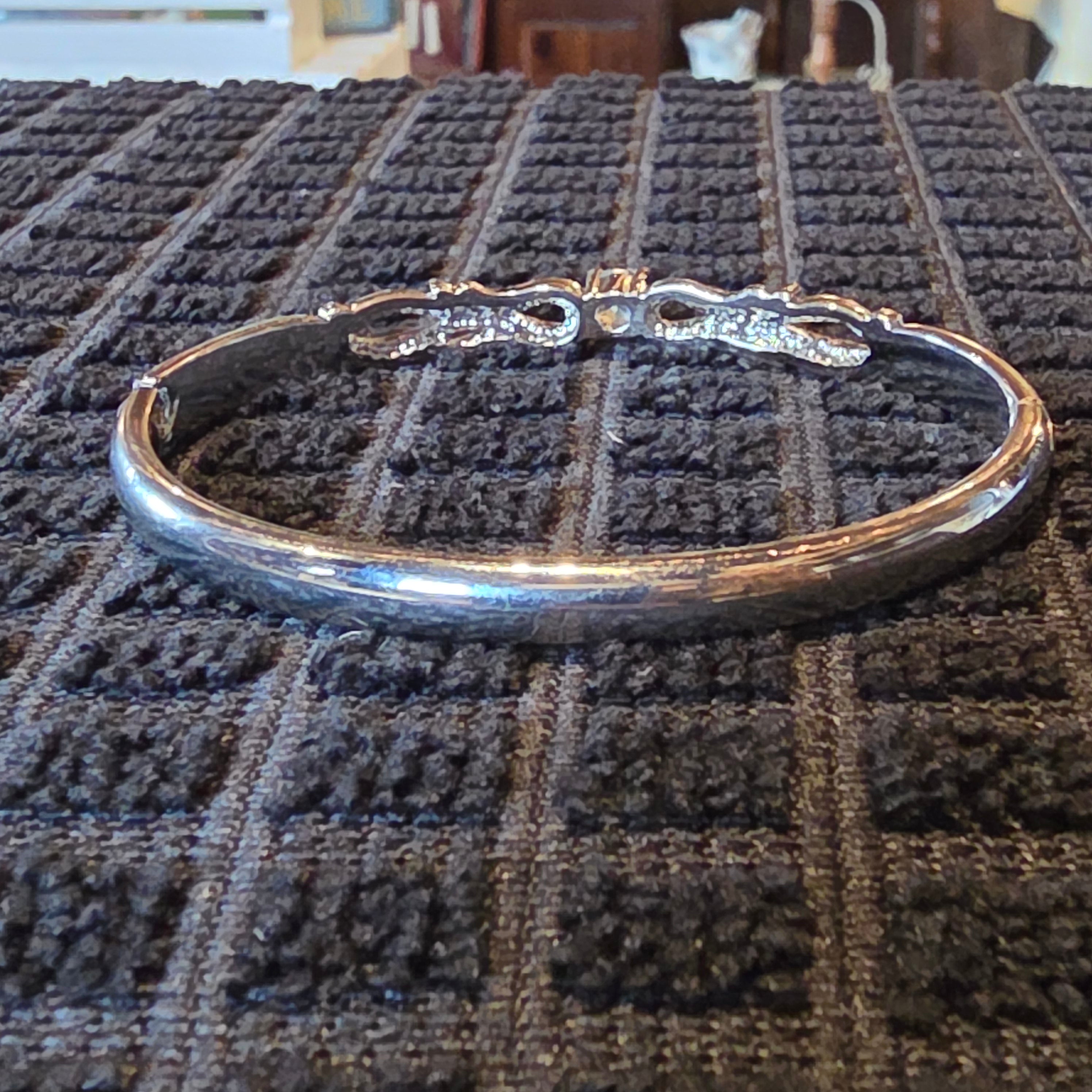 Silver tone bangle w/ blue stone