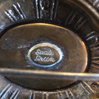 Vintage Sadie Green Art Deco Revival Stamped Brass Brooch, Purple Glass Center