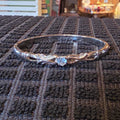 Silver tone bangle w/ blue stone