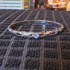 Silver tone bangle w/ blue stone