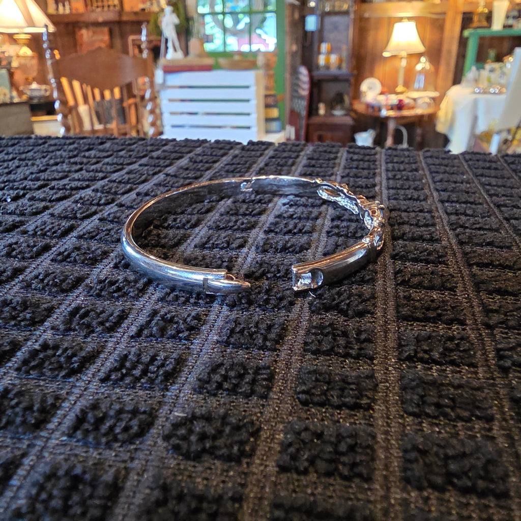 Silver tone bangle w/ blue stone